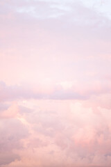 Wall Mural - Sky with soft and fluffy pastel pink and blue colored clouds. Sunset background. Nature. sunrise. Instagram toned style. Vertical