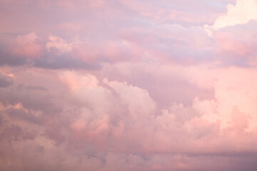 Wall Mural - Sky with soft and fluffy pastel pink and blue colored clouds. Sunset background. Nature. sunrise. Instagram toned style