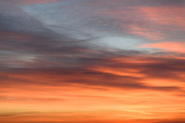 Wall Mural - Sky with soft and fluffy pastel orange pink and blue colored clouds. Sunset background. Nature. sunrise. Instagram toned style