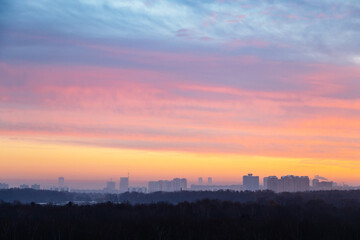 Wall Mural - colorful sky over city and park at cold dawn in winter morning