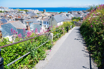 Wall Mural - View of rooftops in St Ives, west Cornwall, South West England. Beautiful blue sea on the background. Selective focus