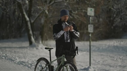 navigation, gps positioning, routing, offline map in a smartphone. male cyclist stopped while cyclin