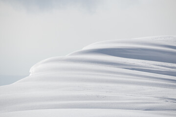 Wall Mural - shadows and light on mountain snowdrift cornice