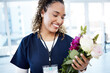 © Rene La/peopleimages.com - Achievement, celebration and a doctor with flowers at a hospital for a promotion and gift for work. Care, happy and female nurse with a bouquet as a present for promotion in healthcare nursing job