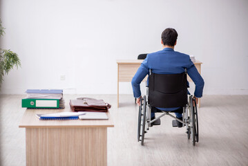 Wall Mural - Young male employee in wheel-chair