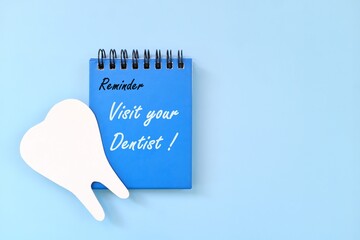 Wall Mural - Visit your dentist reminder on blue desk calendar. Dental and oral health care concept.