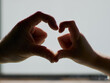 © Cavan Images - heart shape created by joining two mother and son's hands