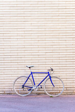 Vintage Blue Bike Leaning On A City Brick Wall