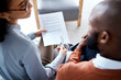 © Rene La/peopleimages.com - Document, medical agreement and black man with woman sign paperwork, health insurance and legal contract. Communication, doctor in psychology and patient, consultation to explain terms and conditions