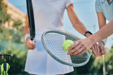 tennis training, hands and ball with women and athlete on outdoor turf, instructor or coach, fitness