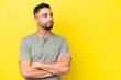 © luismolinero - Young Arab handsome man isolated on yellow background looking to the side