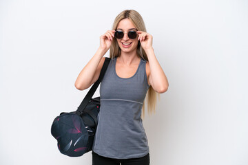 Wall Mural - Young sport woman with sport bag isolated on white background with glasses and surprised