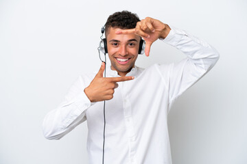 Wall Mural - Telemarketer Brazilian man working with a headset isolated on white background focusing face. Framing symbol