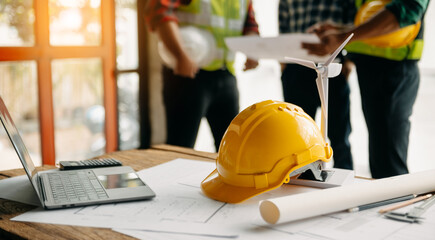 Engineer teams meeting working together wear worker helmets hardhat on construction site in modern city.Asian industry professional team.