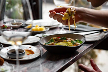  man hand eating pasta at a restaurant