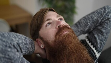 Poster - Young redhead man relaxed with hands on head sitting on sofa at home