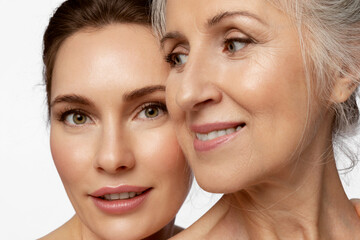 Wall Mural - Beauty portrait of beautiful women of two generations on white background.