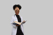  young woman medical student with textbooks looks at camera and smiles. on gray background