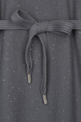 Wall Mural - gray fabric with sequins tied with lace