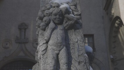 Poster - Russia Vyborg 02.11.2023 Stone bas-relief boy with fruit on street of city