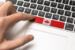 Computer key with the Canada on it. Male hand pressing computer key with Canada flag.