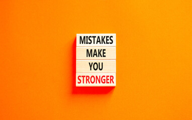 Wall Mural - Mistake make stronger symbol. Concept words Mistakes make you stronger on wooden blocks. Beautiful orange table orange background. Business mistake make stronger concept. Copy space.