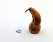 A very ripe pear next to medicines or blue pills. Concept of erection problems, impotence or erectile dysfunction 