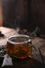 Tea with thyme in a transparent mug