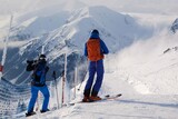 Fototapeta  - Colorful silhouettes of skiers on slope of Kasprowy Wierch Peak in Tatras Mountains. Tatra National Park, Poland