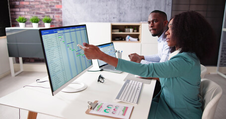 Poster - Young Businesspeople Analyzing Gantt Chart