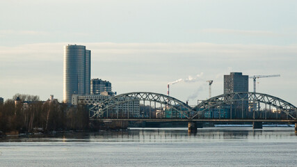  panorama of the city of riga, in the photo the railway bridge and high-rise buildings against the gray sky
