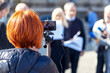 © Mihajlo Maricic - Press or news conference, mobile journalist filming media event with a smartphone. Mobile or citizen journalism concept.