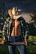 Portrait of sexy unrecognizable farmer or cowboy in hat