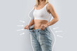 © Prostock-studio - Cropped of slender woman wearing huge jeans, collage