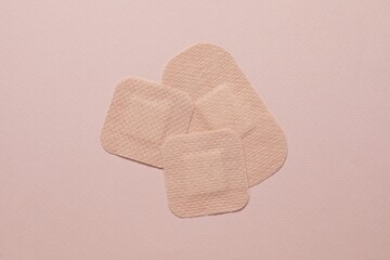 contraceptive patches on pink background, flat lay
