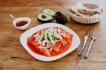 Wall Mural - mexican red enchiladas for breakfast in Mexico Latin America