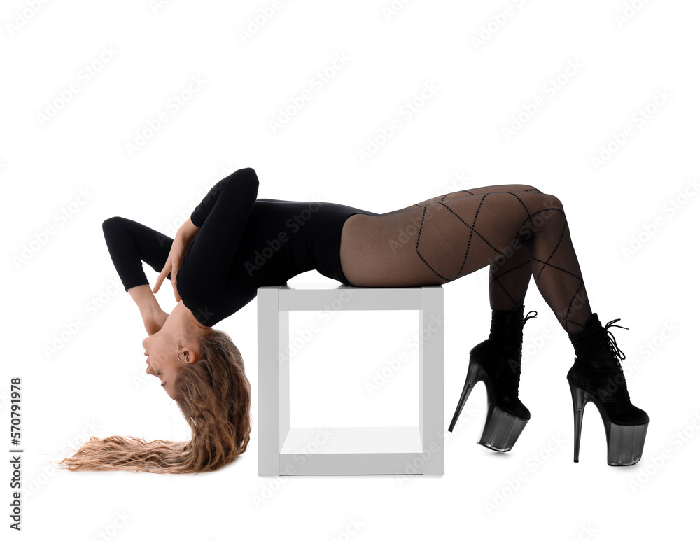 Attractive female dancer in high heels on white background