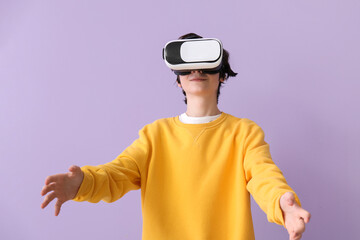 Poster - Teenage boy in VR glasses on lilac background