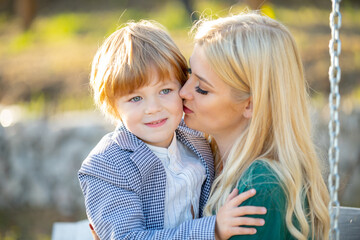 mothers love. closeup portrait of mother and child kissing. mother hugging and embracing son. mother