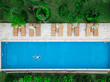 © Cavan Images - Aerial view of attractive woman floating over water at resort