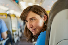 Mature woman on airplane seat