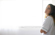 © Cavan Images - Tired nurse leaning on wall in hospital corridor