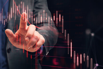 Poster - Close up of businessman hand pointing at downward red candlestick chart on dark background. Financial crisis and recession concept. Double exposure.