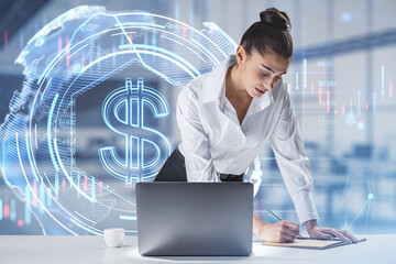 Aufkleber -  businesswoman leaning and writing on desktop with laptop and glowing dollar hologram on bright blurry office interior background. Money, digital banking and finance concept. Double exposure.