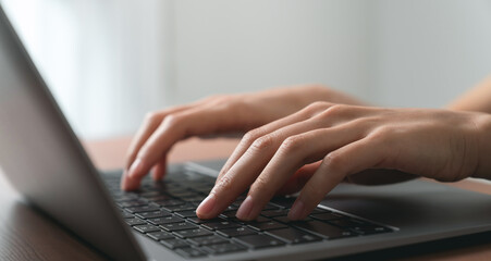 Sticker - Hand using computer laptop and touching mouse on the table.