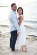 © Cavan - romantic couple at beach embracing and looking off camera