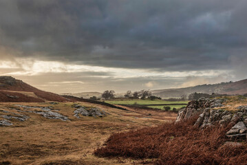 Wall Mural - Stunning Winter sunset golden hour landscape image of view from Wast Water over countryside in Lake District towards the Western district