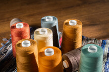 Reels Of Threads For Sewing. Spools Of Thread. Pile Of Cotton Reels. Bobbins With Colorful Threads. Color Sewing Threads. Needlework, Handmade. Close-up Horizontal Format