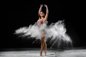 Young slim woman with spread flour on the air