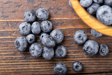 Sticker - Fresh blueberry in wooden bowl. Concept of healthy and dieting eating.